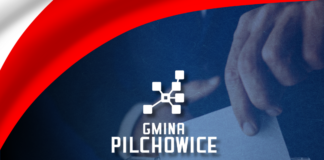 Grafika - wybory - kartka wrzucana do urny wyborczej + logo gminy + wstęga biało-czerwona